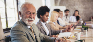 Group of professionals sitting at table.