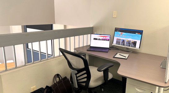 In-use hot desk in mezzanine.